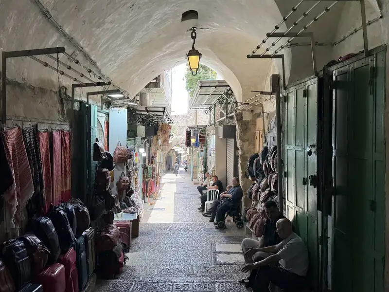 Une ruelle voûtée de la vieille ville de Jérusalem, avec ses échoppes et ses habitants